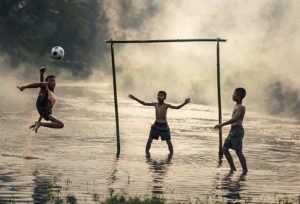 boys playing football